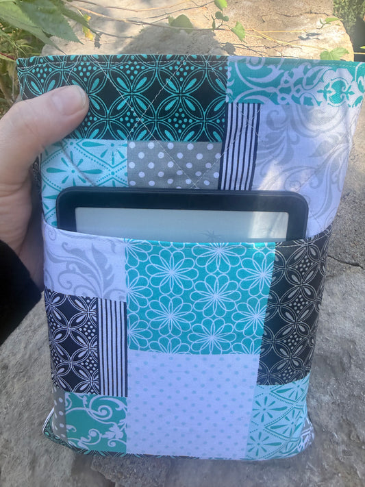 Patchwork book sleeve with an e-reader in the front pocket