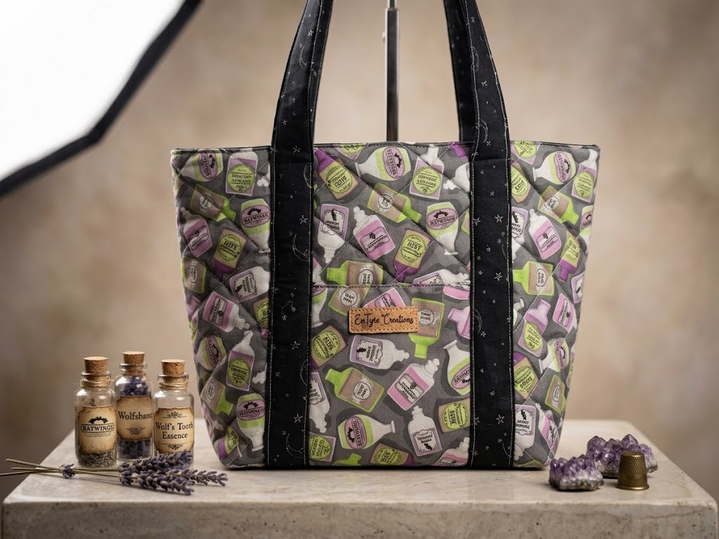 Potion Shelf quilted tote bag with EnTyre Creations cork tag beside apothecary bottles and lavender