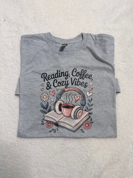 Gray Reading, Coffee & Cozy Vibes tee with a coffee cup, headphones, and open book design